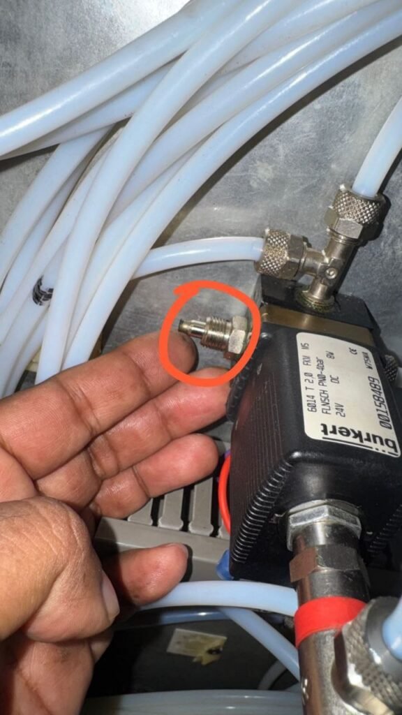 Suction valve component removed for inspection near Burkert solenoid valve